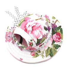 a white hat with pink flowers on it