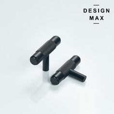 two black knobs on white background with the words design max above them and below it