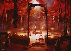 an image of a stage setting with red curtains and people on the stage in the background