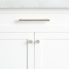 a white cabinet with two handles on it