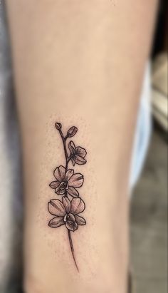 a small flower tattoo on the ankle