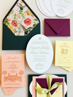 the wedding stationery is laid out on top of each other, with matching envelopes