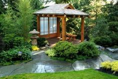 a small wooden gazebo surrounded by lush green trees