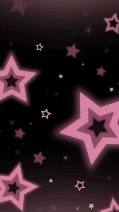 pink stars are flying in the air on a black and purple background with white stars