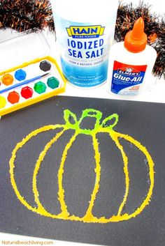 a chalk drawing pumpkin next to some paint