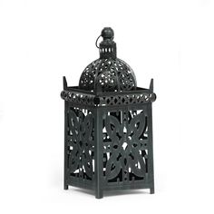 an ornate black metal container on a white background