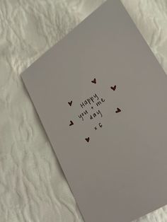 a card that says happy new year and hearts on the front with black ink in it