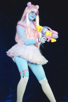 a woman dressed in blue and pink holding a toy