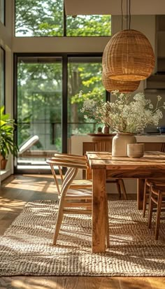 a dining room table and chairs in front of an open window with lots of natural light