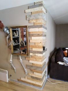 a living room filled with furniture and wooden pallets on the wall next to a couch