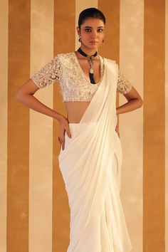 Ivory pre-draped solid saree crafted in chiffon. Paired with a half sleeves deep U neck blouse with all over misty pearl bloom embroidery. - Aza Fashions Wedding Draped Cutdana Blouse, Elegant Draped White Blouse, Elegant White Draped Blouse, Elegant Draped Cutdana Blouse, Elegant Draped Blouse With Cutdana, Elegant White Pre-draped Saree In Traditional Style, White Georgette Blouse For Reception, Traditional Wedding Blouse With Draped Sleeves, Elegant White Pre-draped Saree With Traditional Drape