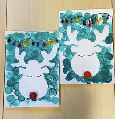 two pieces of paper cut out to look like reindeers with christmas lights on them