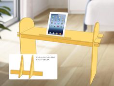 an ipad is sitting on top of a yellow table in the middle of a room