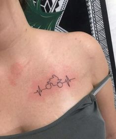 a woman with a heartbeat tattoo on her chest