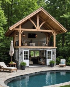 a pool house with an outdoor living area next to it and patio furniture around the pool