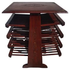 a wooden table that has many pieces of wood on it and is stacked up in the shape of a tree