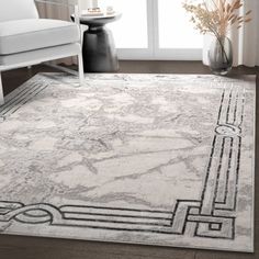 a white rug with an abstract design on it