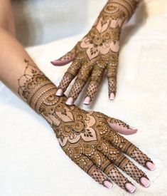 two hands with henna designs on them