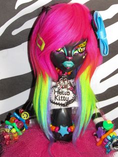 a close up of a doll with colorful hair and accessories on it's head