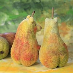 two pears with yellow and red paint on them