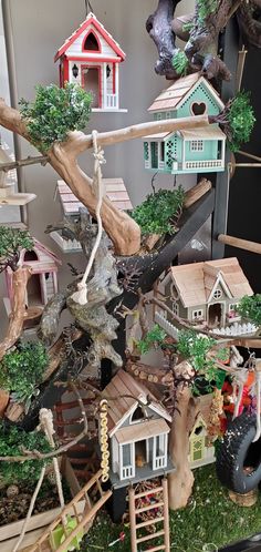 a collection of miniature houses and trees on display