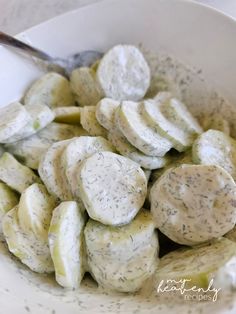 a white bowl filled with cucumber and cheese