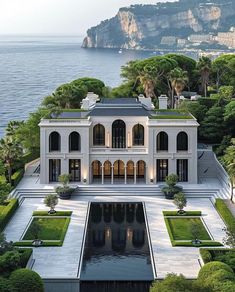 this is an aerial view of a mansion with a pool in the foreground and trees surrounding it