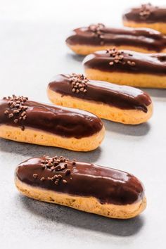 chocolate covered donuts lined up on a table