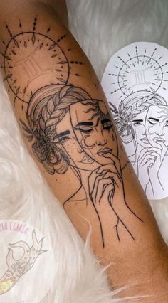 a woman's arm with a tattoo on it and a drawing behind the arm