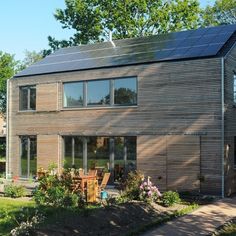 a wooden house with solar panels on the roof