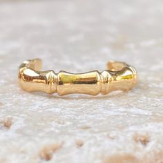 Polished 14KT yellow gold bamboo band design toe ring. Modern, yet earthy style toe ring perfect for your next vacation. Width: 3mm One size; adjustable Stamped 14K Weight: 1.07g Solid 14K Saint Jewelry, Earthy Style, Band Design, Toe Ring, Fabric Ribbon, Gold Polish, Toe Rings, Summer Wear, Gifts For Teens