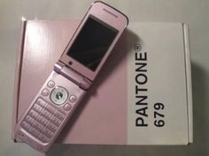 a pink cell phone sitting on top of a box next to it's packaging