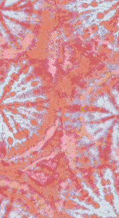 an orange and pink tie dye pattern with white flowers on it's side, as well as the background