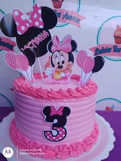 a minnie mouse birthday cake with pink frosting