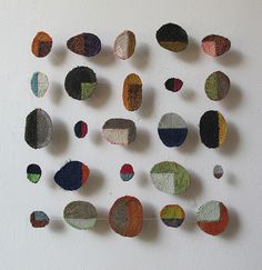 a group of different colored circles hanging on a wall