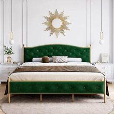 a bed with green headboard and foot board in a white walled room next to a large window