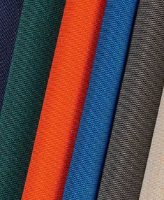 several different colors of fabric are shown in this close up photo, including orange, blue, and black