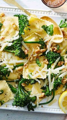 a white plate topped with pasta and broccoli