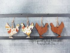 three wooden chickens are hanging from hooks on a gray wood background with text above them