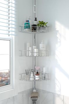 a bathroom with white walls and shelves filled with personal care items