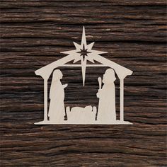 the nativity scene is made out of wood, and has a star above it