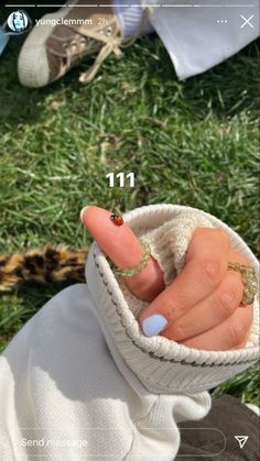 a person with their fingers in a sweater and some rings on her thumb, showing the number 11