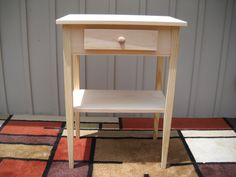 a small wooden table sitting on top of a rug