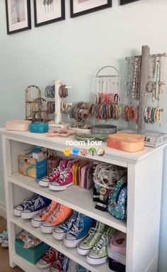 a white shelf filled with lots of colorful shoes