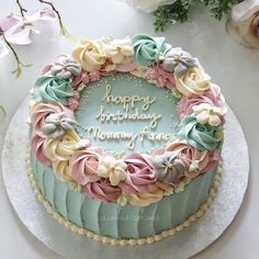 a birthday cake decorated with flowers on a table