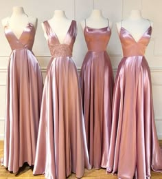 three bridesmaid dresses are lined up on mannequins