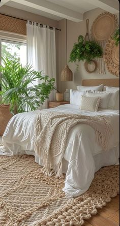 a large bed sitting in a bedroom on top of a wooden floor next to a window