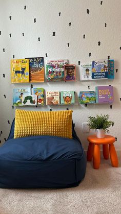 a room with books on the wall and a bean bag chair