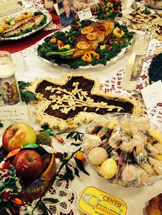 a table topped with lots of different types of food and desserts on top of it