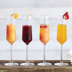 four glasses filled with different types of drinks